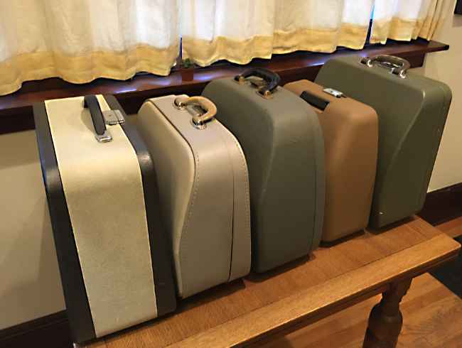 Typewriter cases in a row.